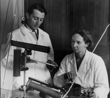 old photograph of two people in a lab