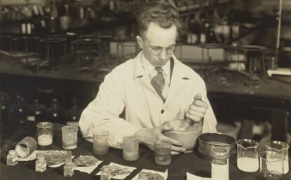 C.C. Dennis using mortar and pestle at Dearborn laboratory