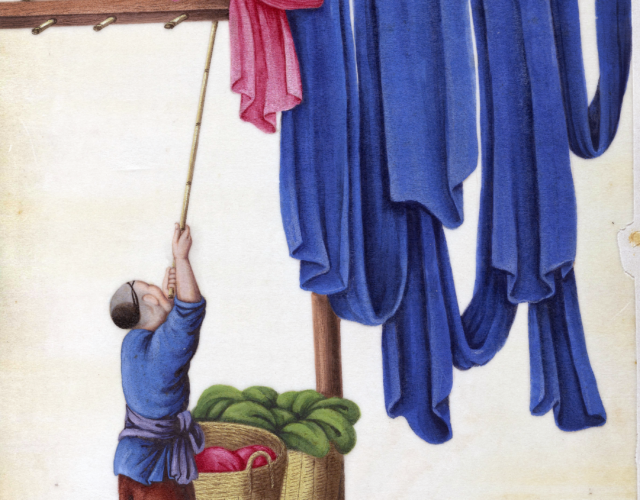 man hanging pink and blue garments on a clothesline