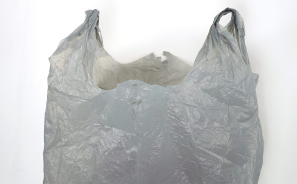 upper section of a white plastic grocery bag with handles, wrinkled